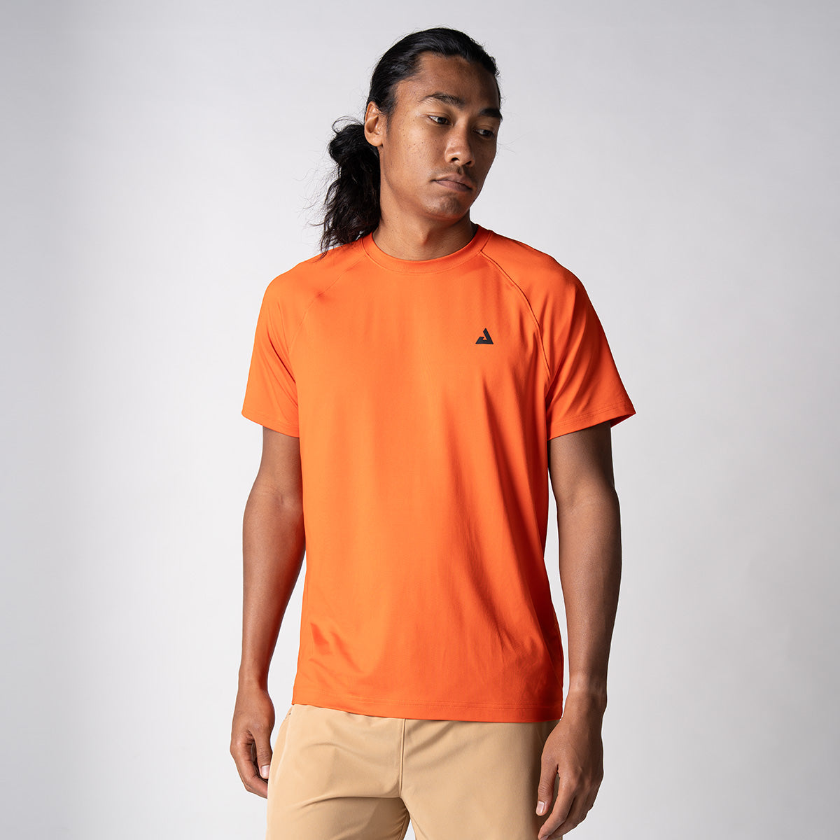 Gray background, male model wearing the JOOLA Men's Court Short Sleeve tee in poppy red.