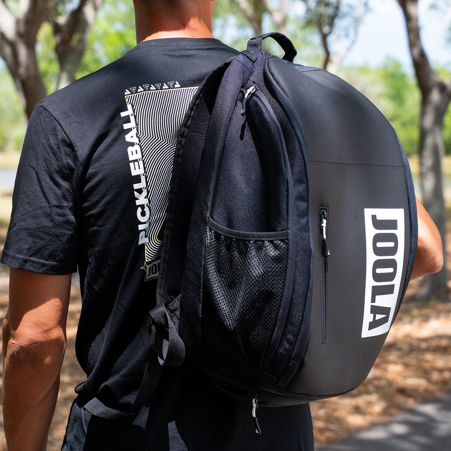 Image of the JOOLA Vision II Backpack over the shoulder of a male model.