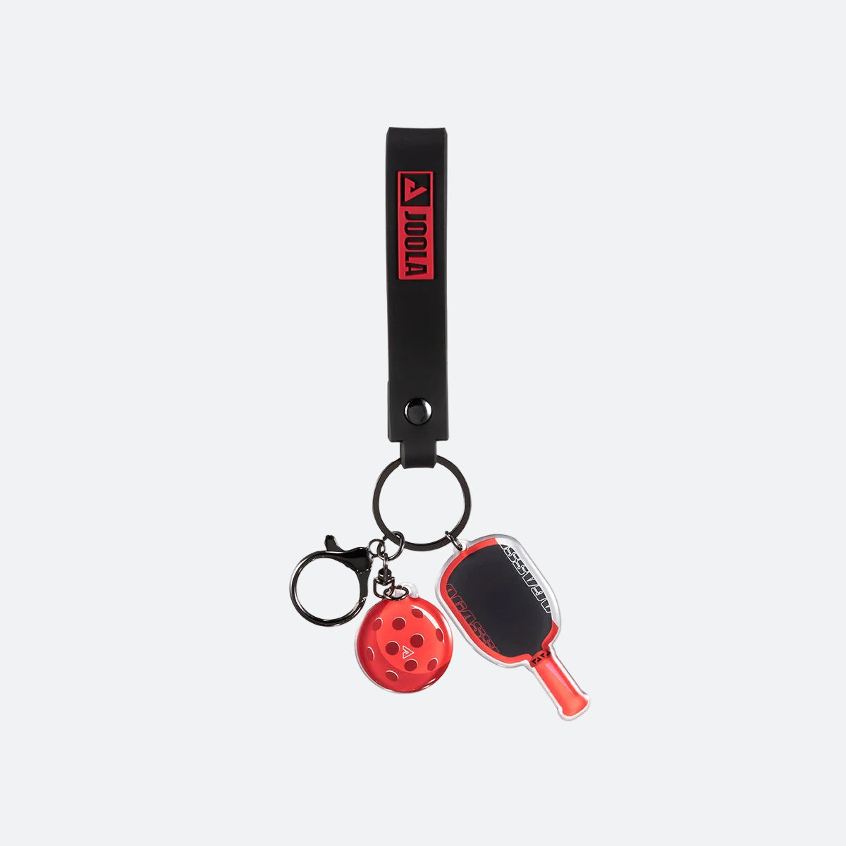 Agassi keychain with paddle and ball charms on a white background.