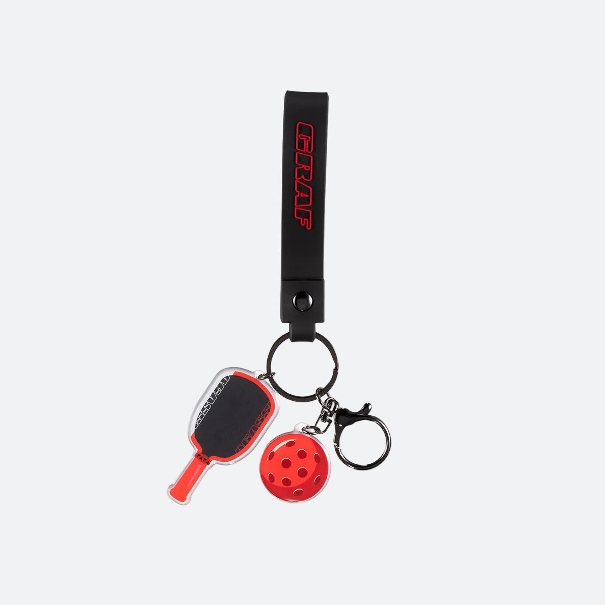 Graf keychain with paddle and ball charms on a white background.