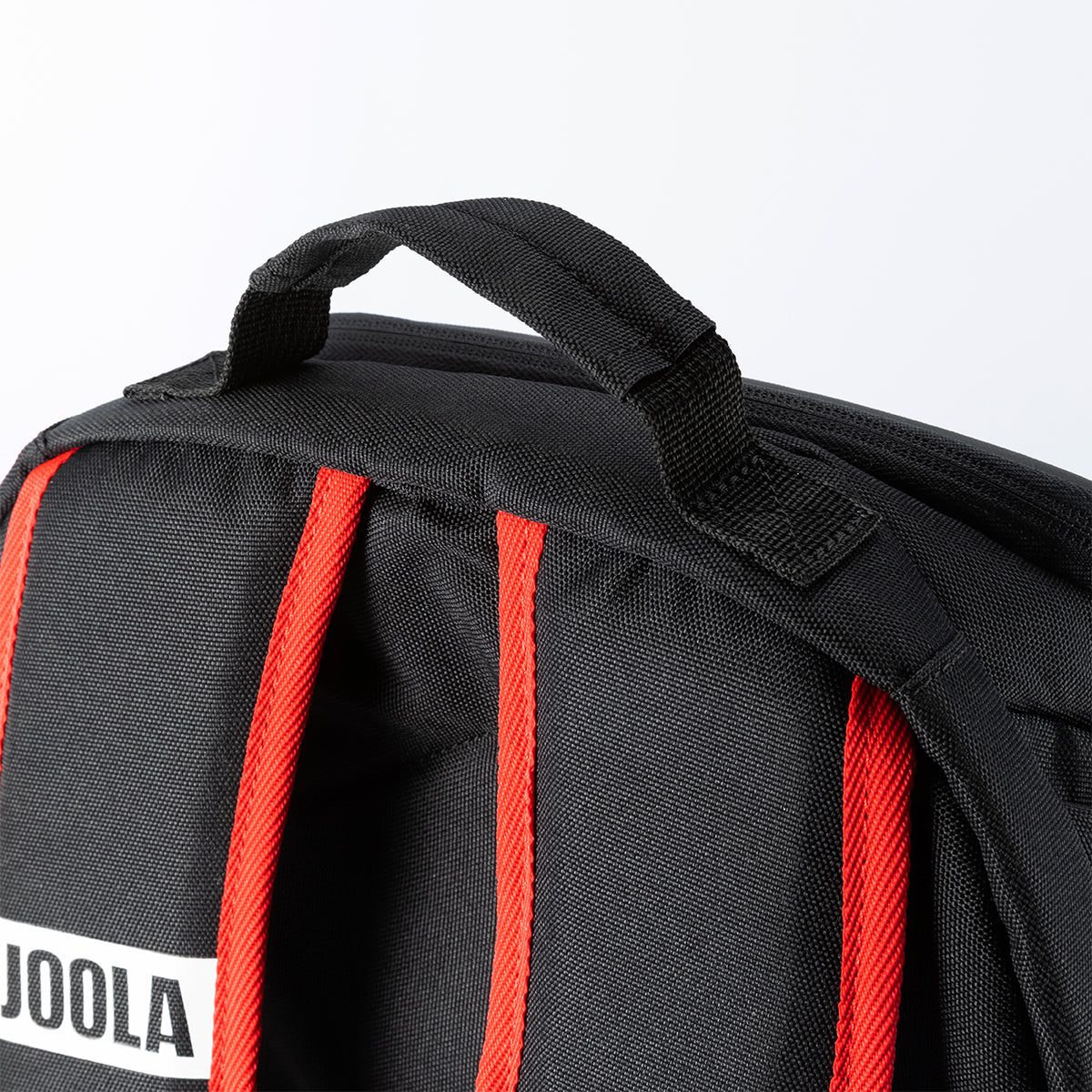 White background, close up on the hook at the top of the Agassi Vision II Deluxe backpack.