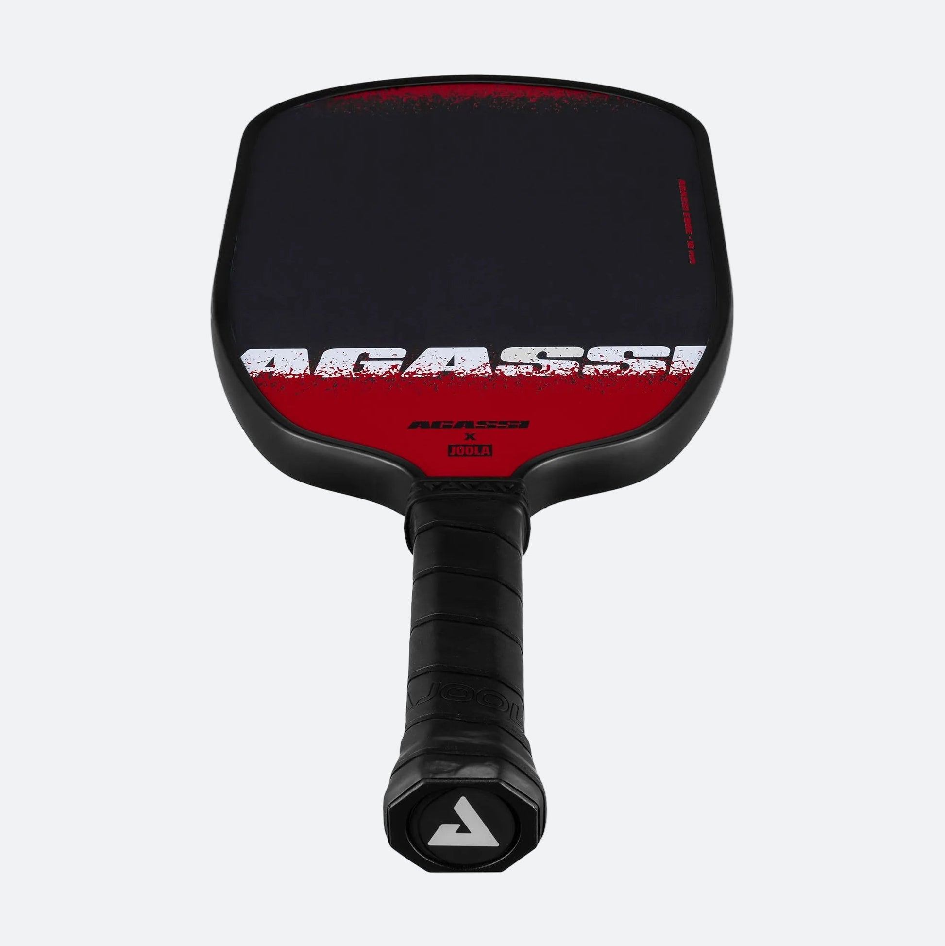 White background, product image of the Agassi x JOOLA Agassi Edge pickleball paddle showing the JOOLA trinity logo on the paddle's end cap.