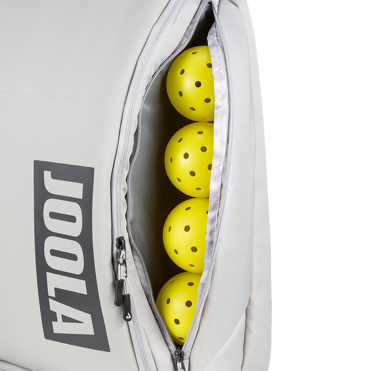 Gray JOOLA backpack showing a side compartment with four yellow JOOLA pickleballs on a white background.