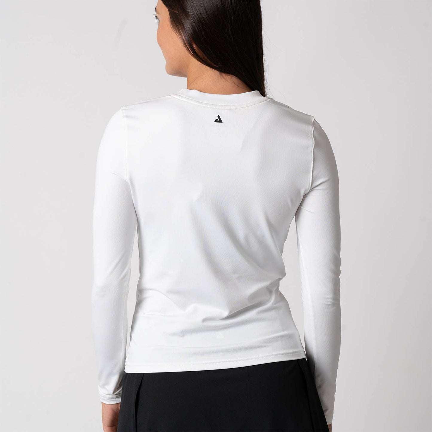 Image showing the back of a female model wearing a JOOLA Women's Court Long Sleeve Shirt, White.